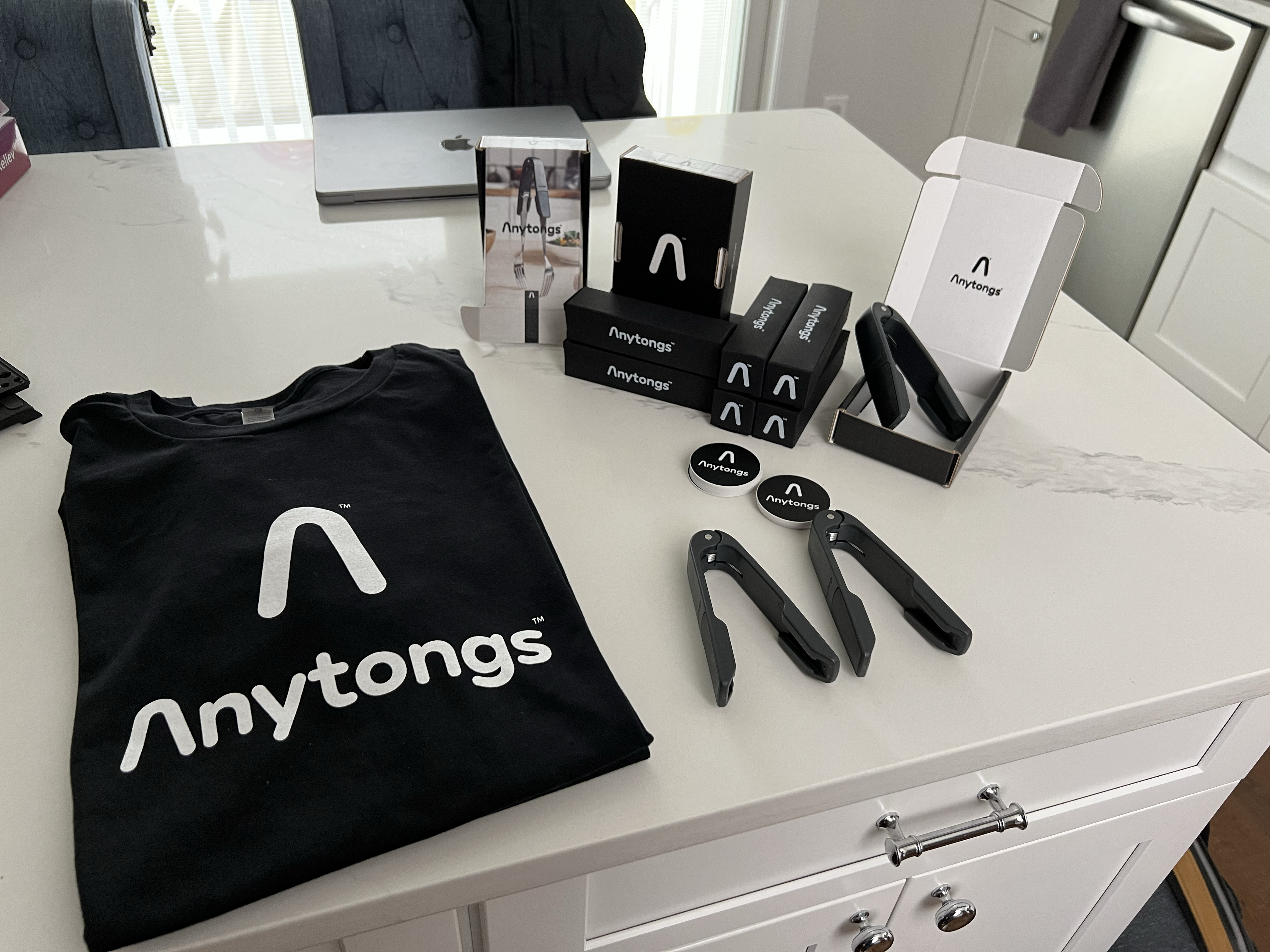 Anytongs brand merchandise — stickers, packaging, and materials